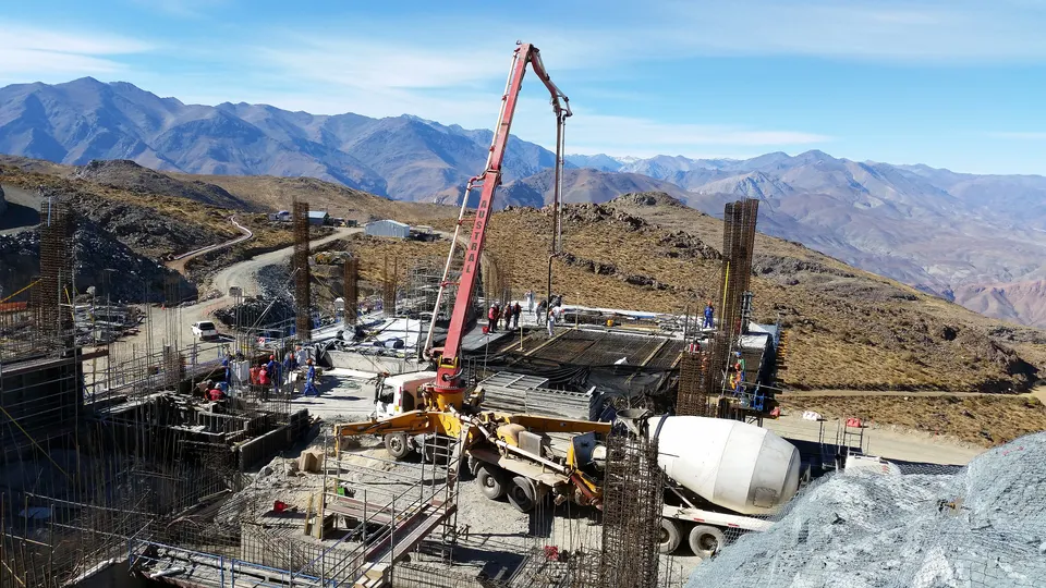 Concrete being poured at a construction site in the mountains